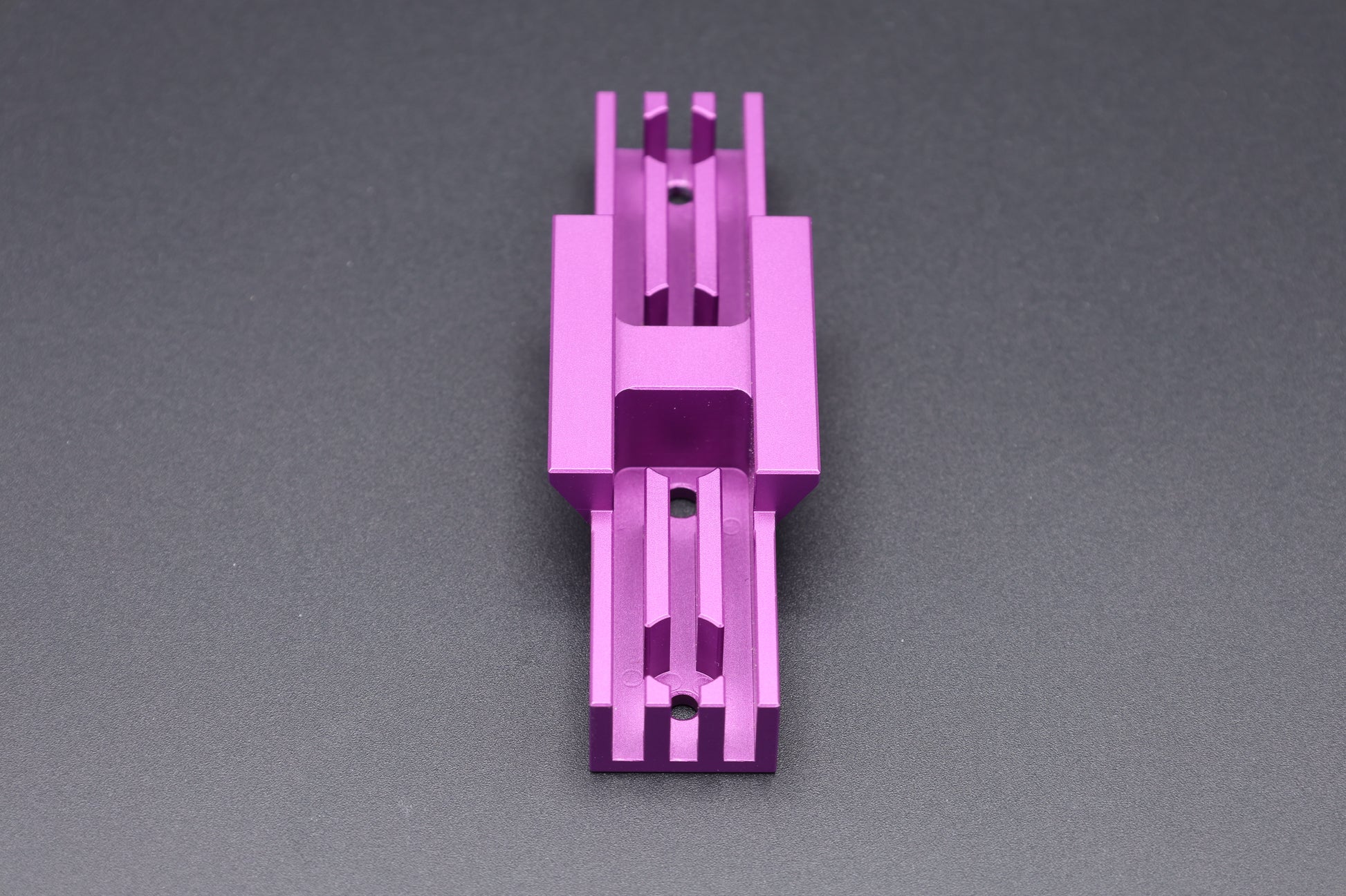 The underside of a purple Gannet Astro mounting bracket showing the heat sink cooling fins and dovetail bracket detail.